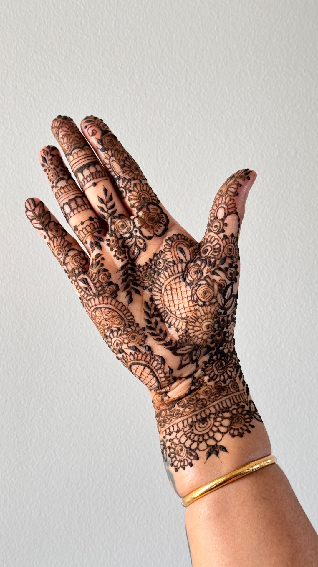 Elaborate bridal henna with intricate mandala and paisley patterns on palm