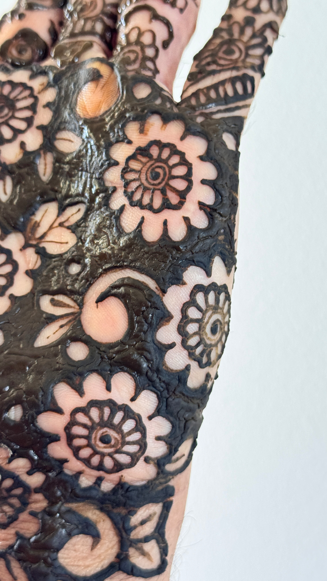 Dark henna stain showing beautiful arm patterns with floral motifs